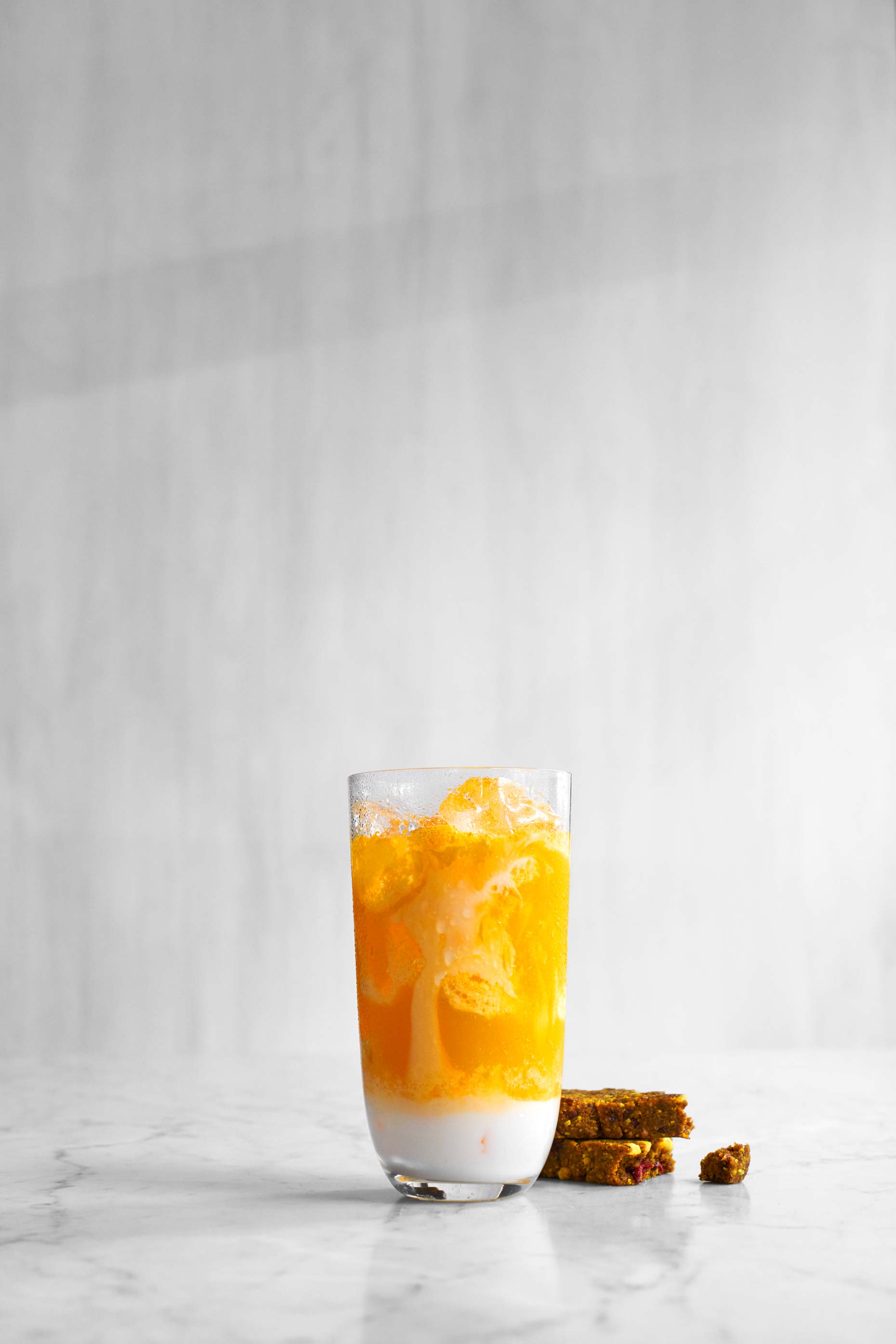 Yellow mango, banana and pineapple smoothie photographed by Food Photographer Adrian Mueller New York