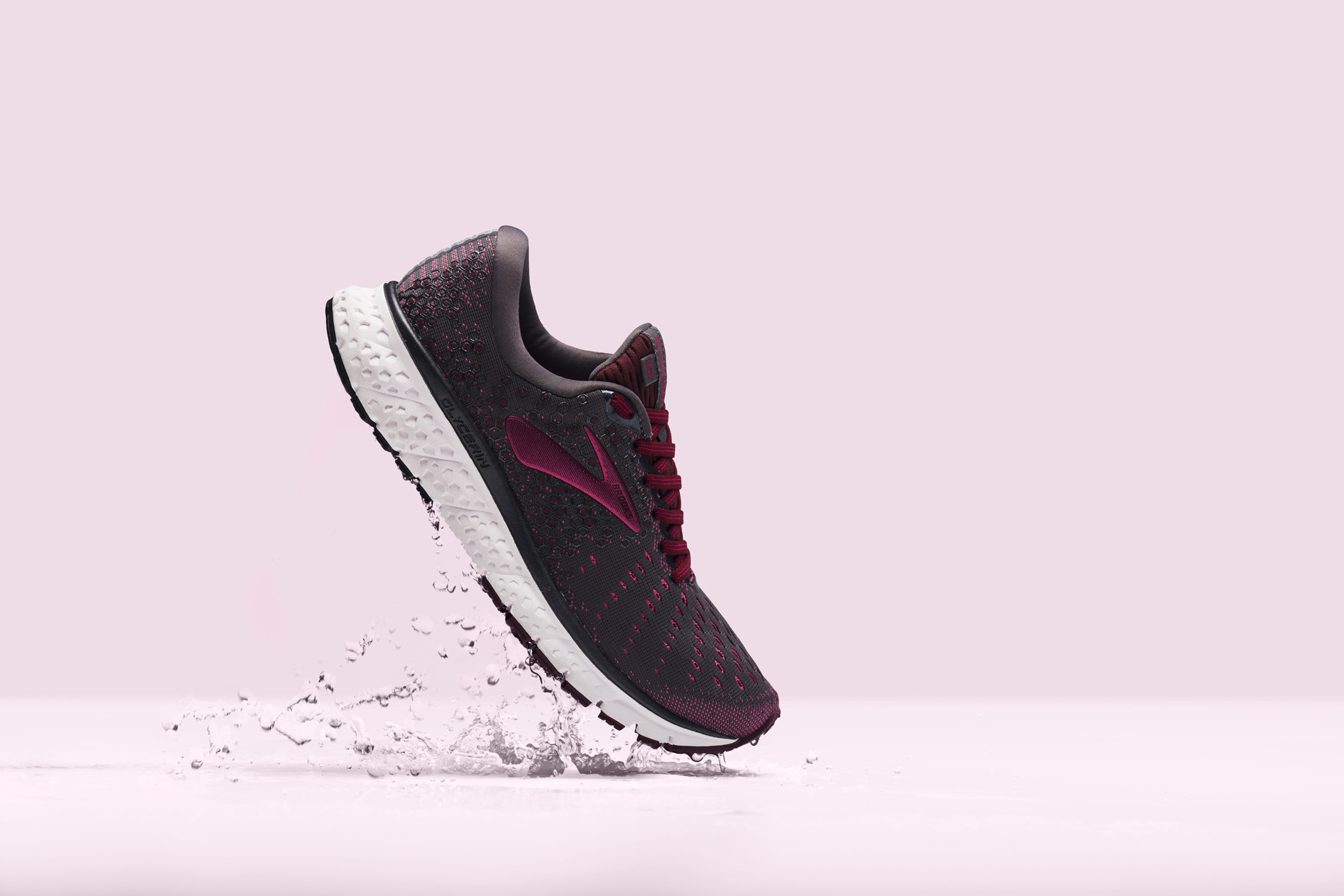 Brooks Street Running Shoe on a pink surface, by still life photographer Adrian Mueller New York